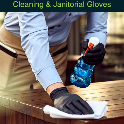 Person cleaning a surface with gloves and a bottle of cleaning solution.