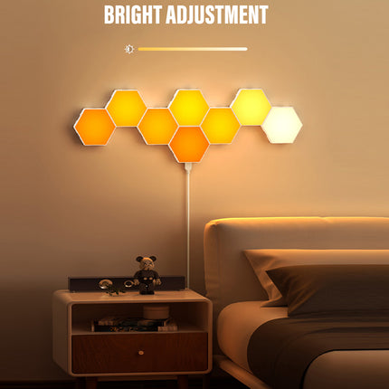 A wall-mounted hexagon light panel set glowing in warm yellow and white tones above a bed in a bedroom, with the text 'BRIGHT ADJUSTMENT' and a brightness slider graphic at the top.