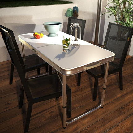 Foldable dining table with chairs on a wooden floor