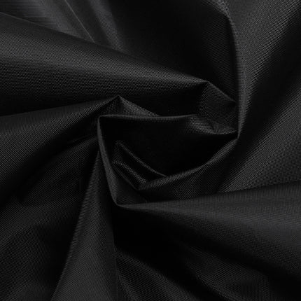 A close-up of black fabric with a subtle woven texture, arranged in a spiral drape to show the material's sheen and folds.