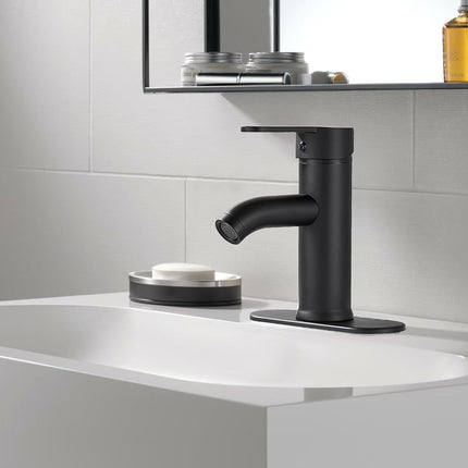 Black faucet on a white sink in a bathroom setting