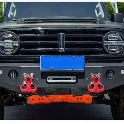 Front view of a black SUV with red tow hooks and a blue license plate.
