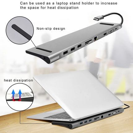 A silver laptop stand and hub shown on a desk with a laptop resting underneath, plus callout circles and text explaining non-slip design and heat dissipation. The product is photographed in a clean indoor setting with a blurred background.