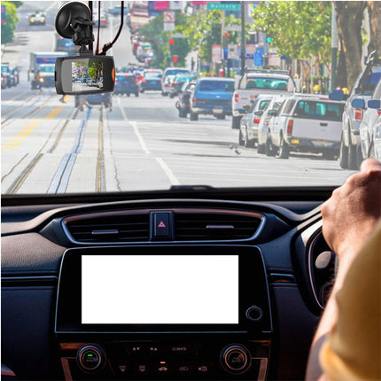 Car interior with a dashboard camera capturing a busy street.