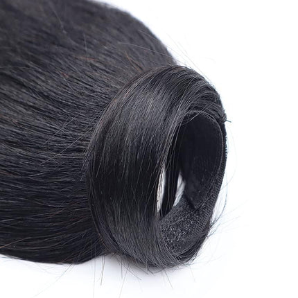 Roll of black hair extensions on a white background