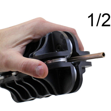 Hand holding a black plumbing fitting with a 1/2 inch label on a white background
