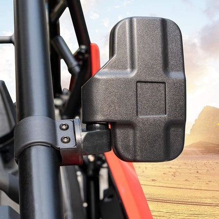 Side view mirror on a vehicle with a desert landscape in the background