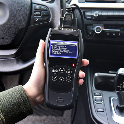 Car diagnostic tool held by a person inside a vehicle