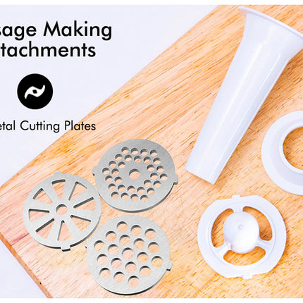 Sausage making attachments including a white plastic tool and metal cutting plates on a wooden board.