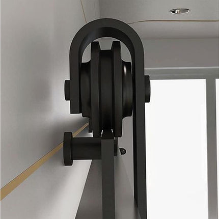 Black metal pulley system on a white background