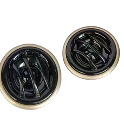 Two round black and gold kitchen drain covers shown on a plain white background.