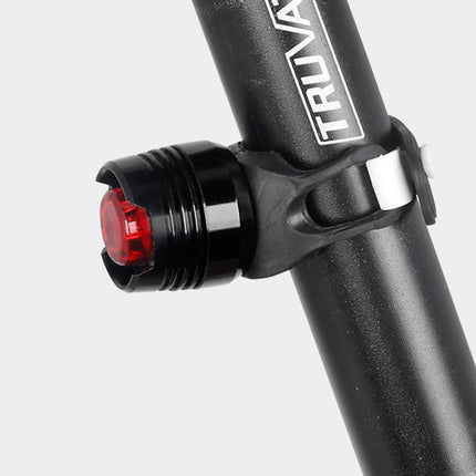 Bicycle light attached to a black frame with 'TRUVATRAX' branding on a white background