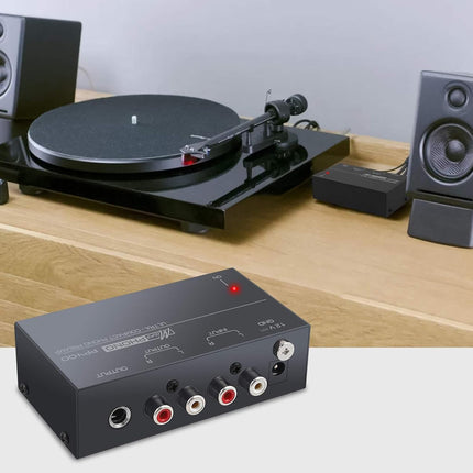 Turntable with speakers and audio interface on a wooden surface
