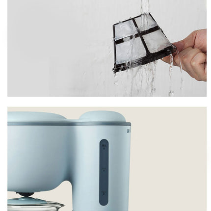 A light blue electric kettle shown with a hand holding a black mesh filter under running water, set against a clean white and beige background.