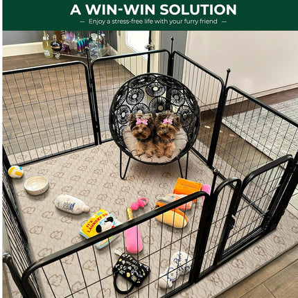 Two small dogs sitting on a chair inside a pet playpen with various toys scattered around.