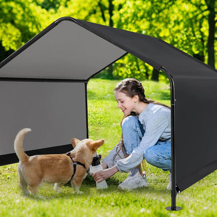 Woman sitting on a chair next to a black pet playpen with a dog inside, outdoors.