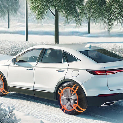 A white SUV parked outdoors in a snowy landscape with trees in the background. The wheels are fitted with orange protective covers or wraps.