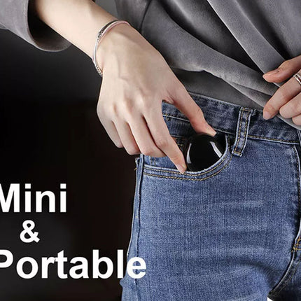 Person adjusting a gray shirt with text 'Mini & Portable' on a dark background