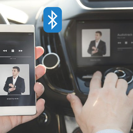 Person using a smartphone to control music on a car's Bluetooth system.