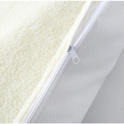 Close-up of a mattress with a zipper detail on a white background