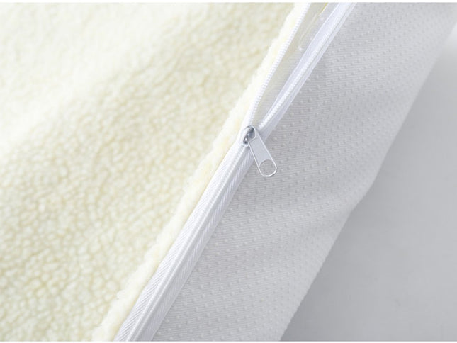 Close-up of a mattress with a zipper detail on a white background