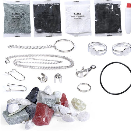 Collection of jewelry-making materials including stones, chains, and tools on a white background