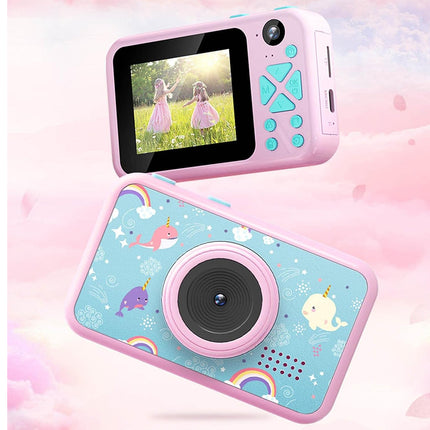 A pink and light blue children's digital camera shown from two angles against a pastel pink cloud background. The top view shows the screen and control buttons, while the bottom view shows the decorated back with unicorn and rainbow illustrations.