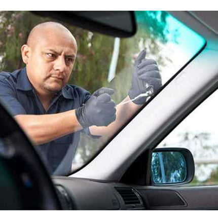 Man repairing a car window with tools
