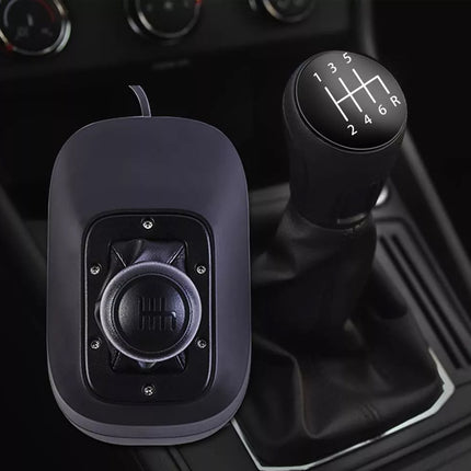 Car gear shift and shifter knob with a black finish on a vehicle interior.