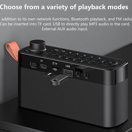 A black portable audio device with a top control panel, USB port, TF card slot, and orange pull tab, shown on a dark surface with promotional text above.