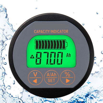 A round black and gray digital capacity indicator battery charger with a bright green LCD screen showing 87.00 Ah, set against a white background with water splash graphics on the sides.