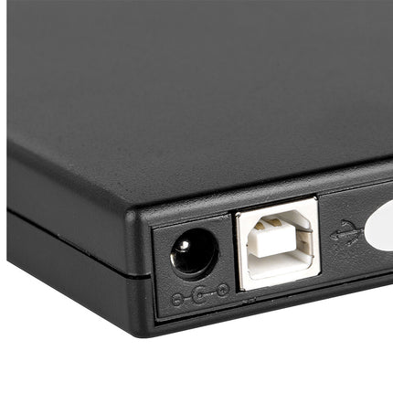 Close-up of a black electronic device with USB port and power button on a white background