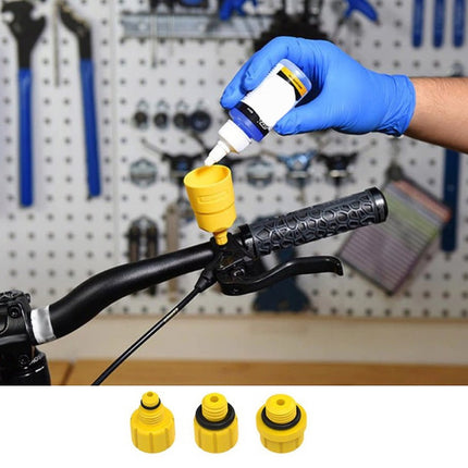Person applying a yellow cap to a bike handlebar with tools in the background
