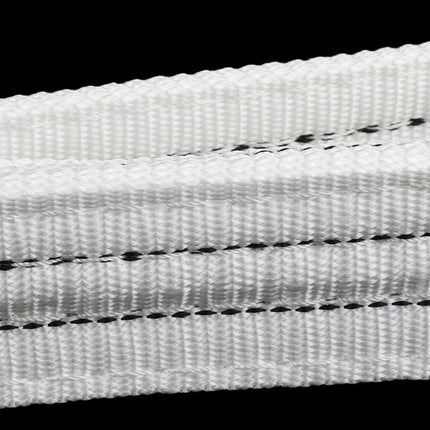 Close-up of white woven fabric with black thread on a black background