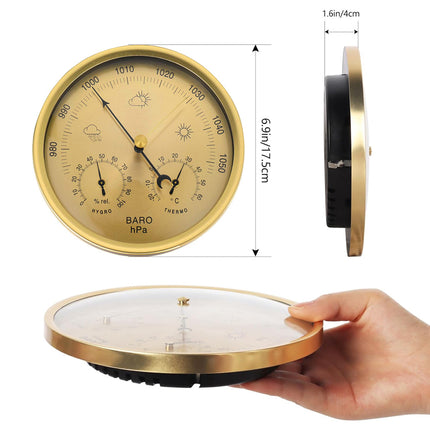 Gold barometer with dimensions and a hand holding it for scale on a white background