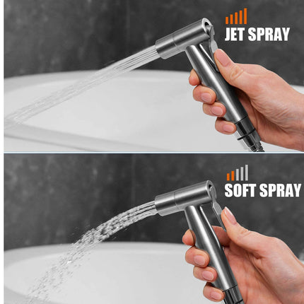 Handheld shower head with jet spray and soft spray options, held by a hand over a sink.