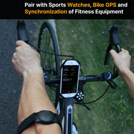 Person riding a bicycle with a digital display on the handlebar, wearing a smartwatch.