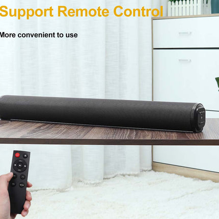 A black cylindrical soundbar sits on a wooden table in a modern room setting, with a hand holding a black remote control in the lower left corner. Yellow and black text at the top reads 'Support Remote Control' and 'More convenient to use'.