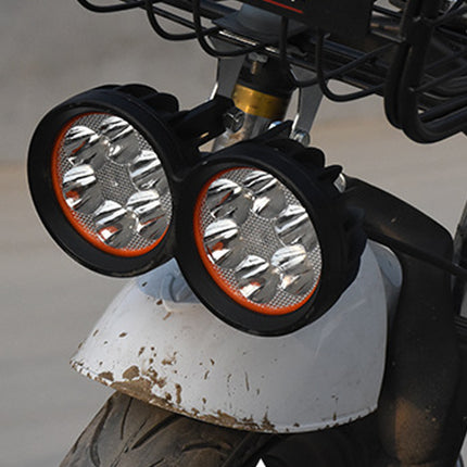 Close-up of motorcycle headlights with a blurred background