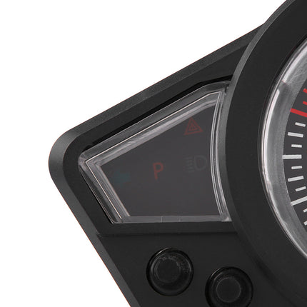 Close-up of a black motorcycle or dashboard instrument cluster showing a small digital display with red 'P' and 'ID' icons, alongside part of a speedometer with red and white markings.