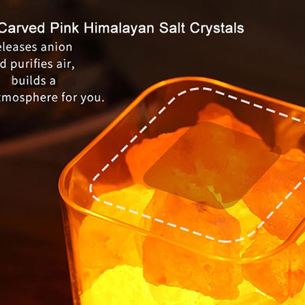 A close-up of a clear square container filled with glowing pink Himalayan salt crystals, with white text on the left describing the crystals and their air-purifying benefits.