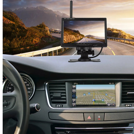 Car dashboard with a rearview monitor displaying a scenic road and a navigation screen.