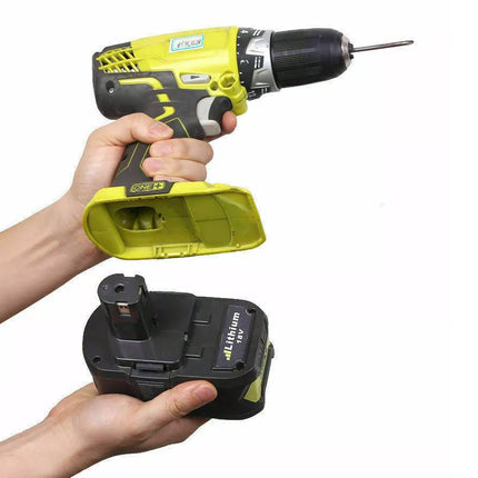 A cordless drill and its detachable battery pack held by two hands against a plain white background.