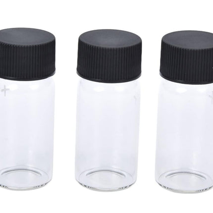 Three clear glass bottles with black lids on a white background