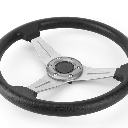 Black steering wheel with silver center on a white background