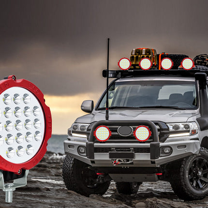 Off-road vehicle with additional lights on a rocky terrain