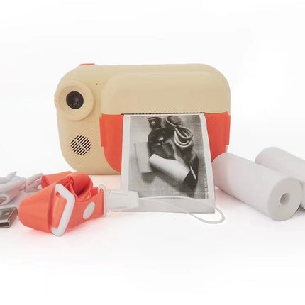 A compact portable photo printer with a beige top and orange-red sides, shown with a printed black-and-white photo emerging from the front, a USB drive, a charging cable, and two white paper rolls on a white background.