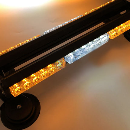LED warning light bar with amber and white lights on a blurred background