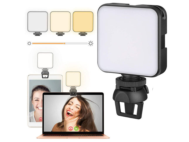 Video call setup with a light on a laptop screen and additional lights on a white background