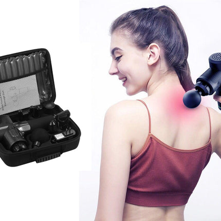 A black handheld massage gun being used on a woman's upper shoulder, shown next to an open black carrying case containing multiple massage attachments.